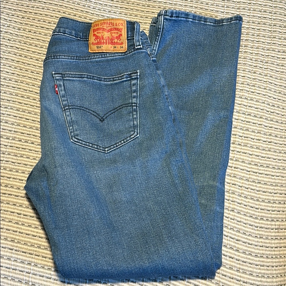 Men’s Levi 514. Distressed blue with navy stitching.